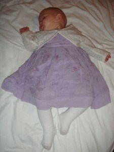 Asleep after a long day, put still in her pretty dress!