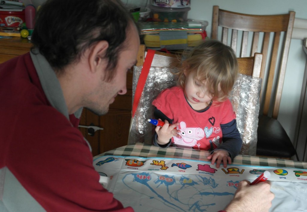 Showing Daddy her new aquadoodle mat!