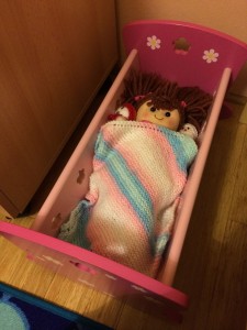 Melody tucked up in her new crib at Christmas