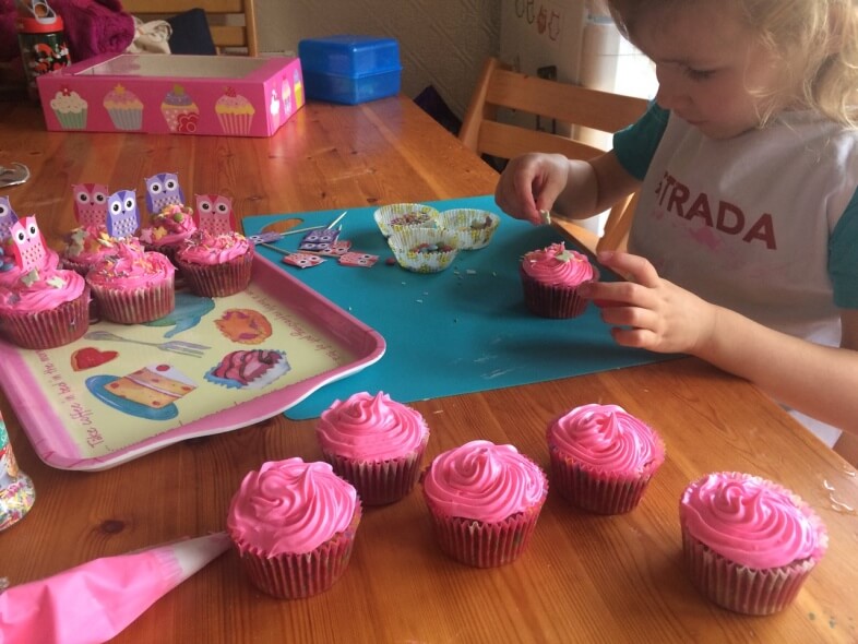 Georgie decorating cupcakes