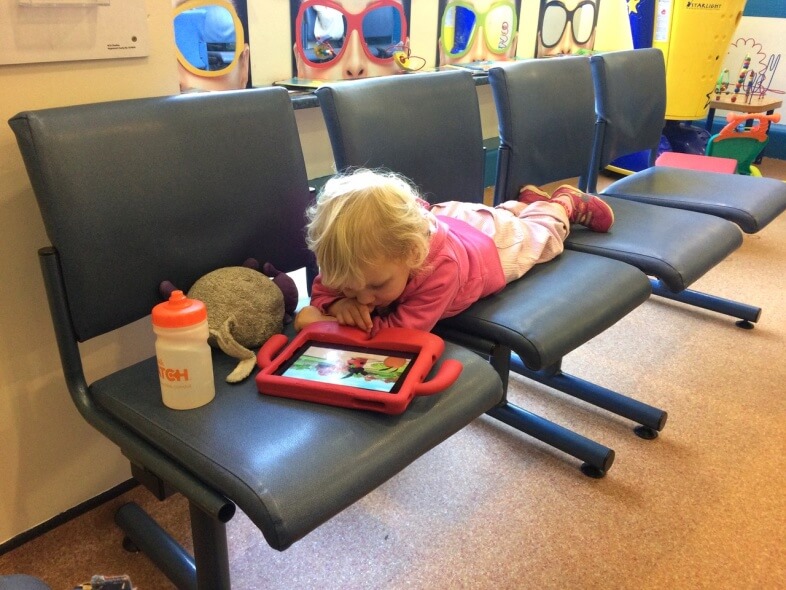 Chilling out in the waiting room between tests while her eyes dilate!