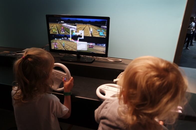 The kids having a go at Mario Kart