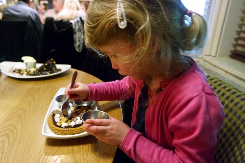 Georgie creating her cookie pizza