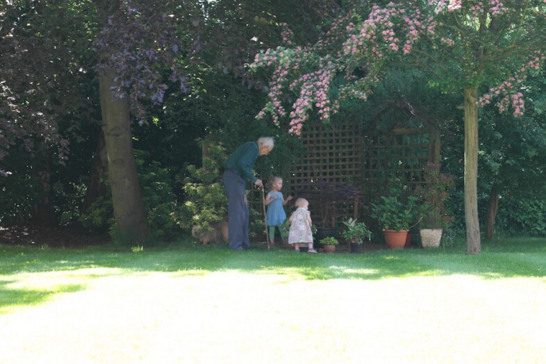 The girls with their Great Grandfather enjoying the garden