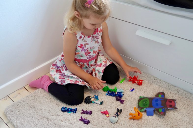 Lydia playing with PJ Masks figure