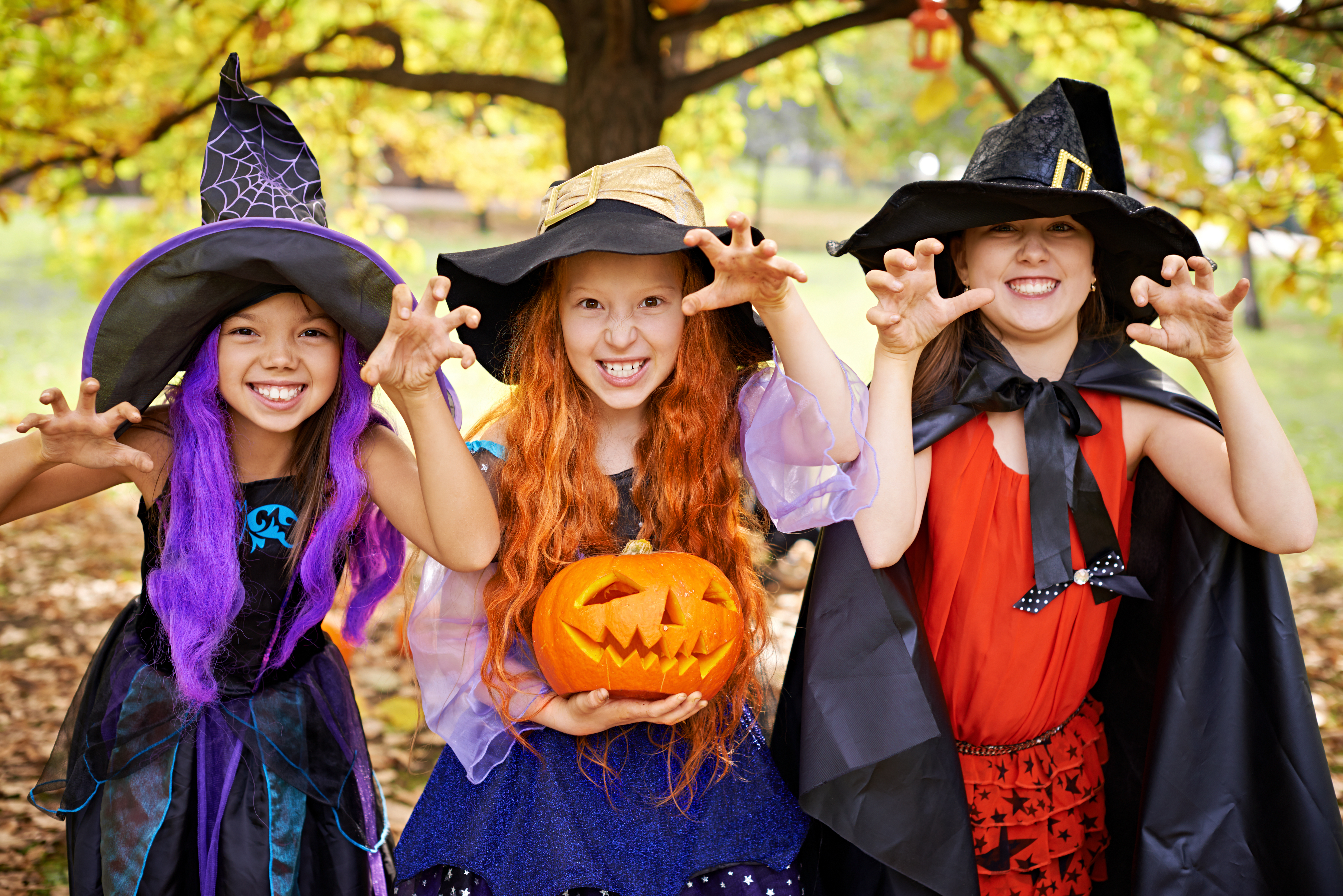 Halloween offspring: three children in stage costumes imitating Halloween children
