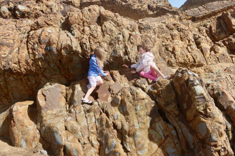 Lydia and Georgie sitting on a rock