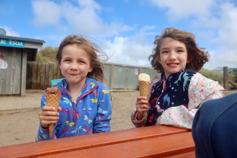 Lydia and Georgie eating ice cream at the beach