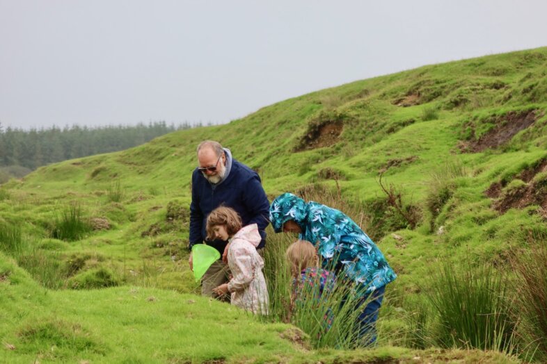 Lydia and Georgie pond-dipping with their Grandparents
