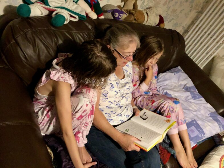 Grandma reading to Lydia and Georgie